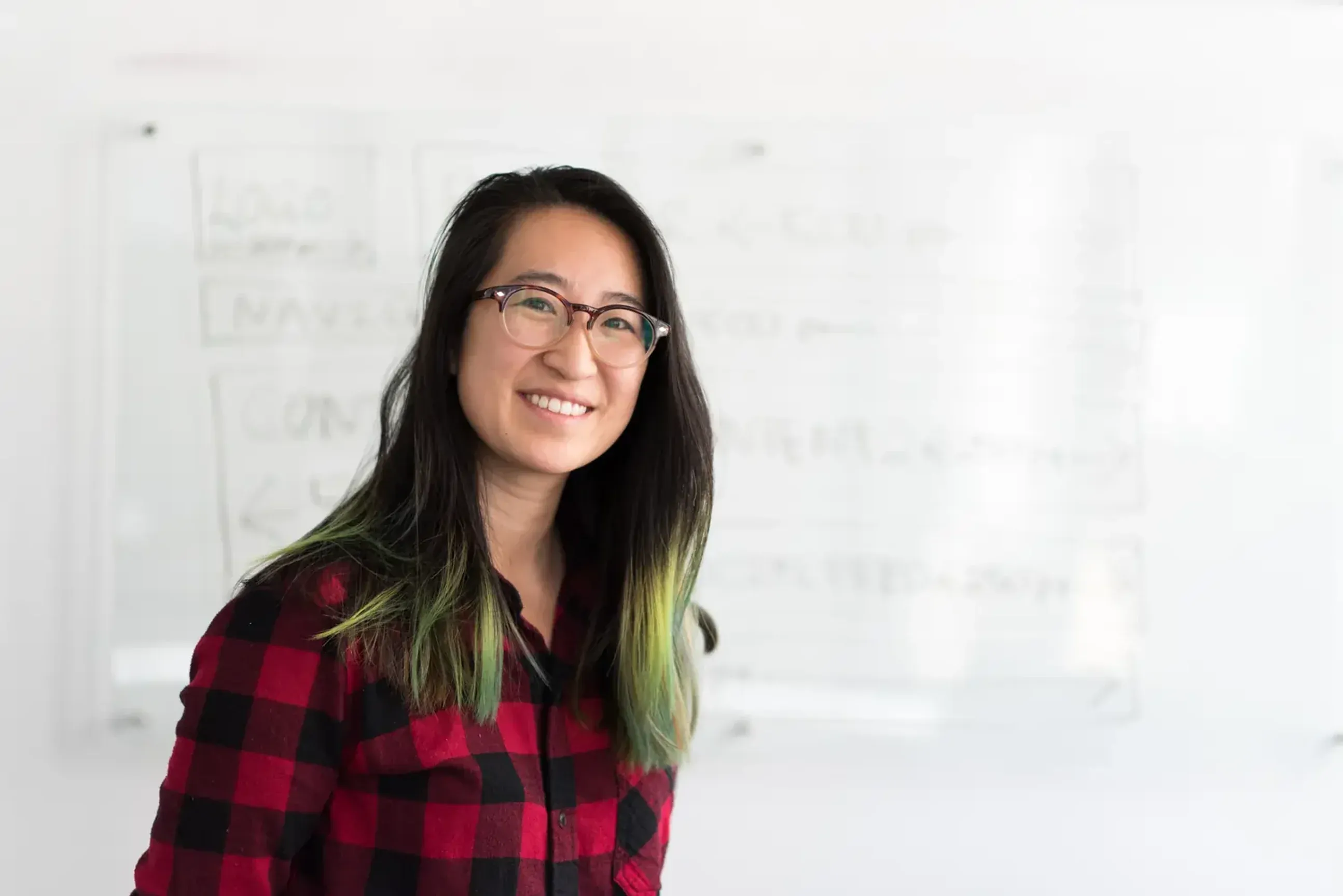 A happy ESL professional using WriteHuman in front of a whiteboard.